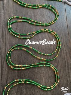 green and gold beaded necklace on a wooden table with the name channi beads