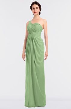 a woman in a long green dress with one shoulder draped over her shoulders and an open back