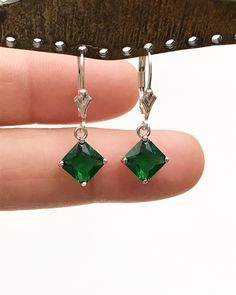 "Sterling Silver Emerald Princess Cut Dangle Earrings Minimalist and Simple Lightweight Earrings Stone: 7mm EmeraldCZ Metal: All components are made from solid .925 Sterling Silver Measurement: Earrings dangle approx. 1\" from top of ear wire *Earrings can be made with either lever backs or french hooks. *Choose Desired Earlier At Checkout You can find other Earrings in my shop here https://www.etsy.com/shop/LinksAndStones?ref=seller-platform-mcnav&section_id=24232772 Please feel free to Con Classic Green Earrings With Ear Wire, May Birthstone Drop Earrings With Ear Wire, Elegant Hypoallergenic May Birthstone Hoop Earrings, Silver Single Earring For May Birthstone, Classic Emerald Dangle Jewelry, Formal May Birthstone Earrings With Ear Wire, Formal Ear Wire Earrings For May Birthstone, May Birthstone Crystal Drop Earrings, Green Sterling Silver Single Earring