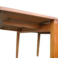 a wooden table with two legs and a drawer underneath it