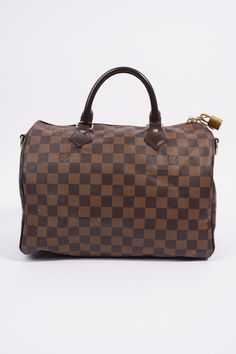 Brand: Louis VuittonStyle: Speedy BandouliereSize: 30cmWidth: 30cmHeight: 21cmDepth: 17cmHandle Drop: 10cmStrap Drop: 48cm - 55cmExterior Condition: ExcellentInterior Condition: Very GoodColour: Damier EbeneInterior Colour: RedHardware Colour: GoldMaterial: Coated CanvasProduct Code: AA4173Manufactured In: FranceComes With: Original Box and Dustbag,Padlock Louis Vuitton Speedy Bandouliere, Speedy Bandouliere, School Bags For Kids, Damier Ebene, Louis Vuitton Speedy, Kids Bags, Womens Backpack, Backpack Bags, Louis Vuitton Monogram