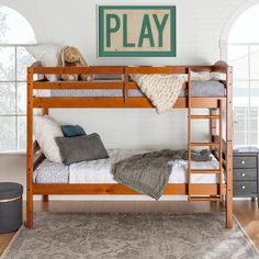 a wooden bunk bed sitting in a bedroom next to a rug on top of a hard wood floor