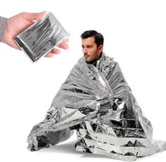 a man sitting on the ground covered in tinfoil