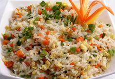 rice with carrots and peas in a white bowl