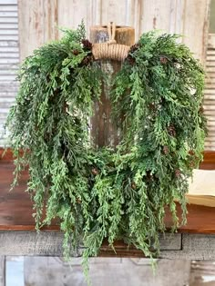 a christmas wreath on top of a wooden table