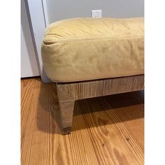 a footstool sitting on top of a wooden floor next to a door way