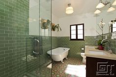 a bath room with a tub a sink and a mirror