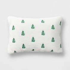 a white pillow with green trees on it