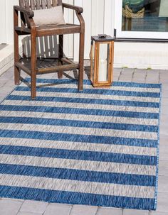 a wooden chair sitting on top of a blue and white rug