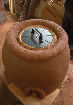 a clock sitting on top of a piece of wood