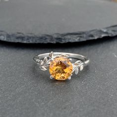 This Citrine Ring features a natural design and showcases a high-quality 8mm citrine stone. If you are looking for a November Birthstone Ring, Yellow Quartz Ring Silver, or Natural Inspired Ring this ring will be a perfect choice.  Why this citrine ring:   - Unique design and handmade from natural citrine. - This gorgeous unique ring is 100% handcrafted by an artisan. - Citrine is believed to bring prosperity, joy, and positive energy, making this piece an ideal gift for those born in November. November Birthstone Ring Topaz, Ring Tree, Topaz Yellow, November Birthstone Ring, Yellow Quartz, Tree Rings, Citrine Stone, Citrine Ring, November Birthstone