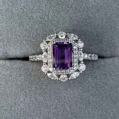 Details: Materials: Amethyst Gemstone, White Zircons, S925 Sterling Silver Plated with 18K White Gold Color: Purple Shape: Retangular Size: Adjustable and fitable for all Descriptions: This elegant ring has a 7x5mm amethyst and forty-four white zircons. Other than the stones, the ring is made out of S925 sterling silver plated with 18K white gold. A ring of small zircons outlined the amethyst. A circle zircon alternates with an oval zircon to create a pattern for the second outline of the ring. Exquisite Multi-stone Amethyst Ring For Anniversary, Exquisite Multi-stone Amethyst Anniversary Ring, Fine Jewelry Cubic Zirconia Gemstone With Center Stone, Cubic Zirconia Gemstones With Halo Setting, Dazzling Cubic Zirconia Gemstones With Halo Setting, Dazzling Amethyst Diamond Ring For Anniversary, Elegant Cluster Amethyst Ring For Formal Occasions, Elegant Formal Cluster Amethyst Ring, Exquisite Cubic Zirconia Gemstones For Anniversary