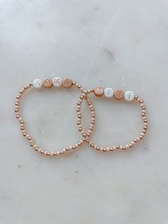 Angela Holm X Just Bead it by Rachel Treat yourself and your mini to the perfect accessory duo: Mama and Mini Neutral Bracelets! Whether you're rockin' a tan and white combo, complete with gold letter beads, or go for a classic 14k gold filled look – these one-of-a-kind bracelets from Angela Holm X Just Bead it by Rachel are exactly what you and your little one need to make a fashion statement any day of the week! This set comes with one Mama Bracelet and you can chose how many mini bracelets yo White Jewelry With Gold Beads For Friendship, Casual Gold Personalized Bracelets, Casual Personalized Gold Bracelets, Casual Gold Stretch Bracelet Personalized, Gold Personalized Casual Stretch Bracelet, Personalized Casual Gold Bracelet, Casual Gold Name Bracelet, Casual Gold Name Bracelet With Letter Beads, Adjustable White Name Bracelet With Gold Beads