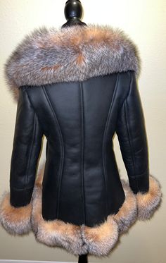 Our gorgeous high low shearling is in black with stunning crystal fox fur. This coat has a zip closure and two pockets. This shearling runs true to size. Black Leather Fur Coat With Faux Fur Trim, Fitted Black Faux Fur Coat, Black Sheepskin Fur Coat With Faux Fur Lining, Luxury Black Sheepskin Fur Coat, Fitted Black Fur Coat With Faux Fur Trim, Luxury Black Fur Coat With Feather Trim, Luxury Sheepskin Fur Coat With Faux Fur Trim, Luxury Black Faux Fur Coat, Fitted Black Sheepskin Fur Coat