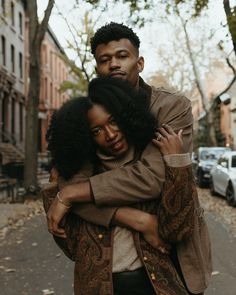 a man and woman hugging on the street