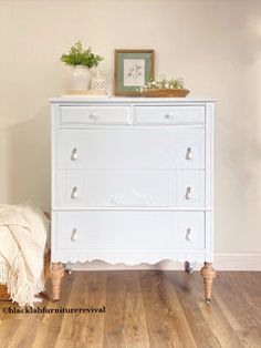 a white dresser sitting on top of a hard wood floor