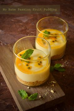 two desserts are sitting on a cutting board with mint garnish around them