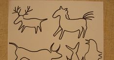 an image of some animals that are drawn in black ink on white paper with brown background