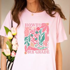 Say HOWDY to a fun teacher t-shirt that is perfect for teachers who love a country flair! Round up some fun and show your school pride with our "Howdy" Western Teacher Tee, with many variations for so many grade levels, Pre-K to 8th grade! This classic unisex jersey short sleeve tee fits like a well-loved favorite. Soft cotton and quality print make users fall in love with it over and over again. These t-shirts have-ribbed knit collars to bolster shaping. The shoulders have taping for better fit Casual Relaxed Fit T-shirt For Back To School, School Spirit Graphic Print Tops For Spring, Spring Graphic Print Top For School Spirit, Pink Relaxed Fit T-shirt For School, School Spirit T-shirt With Funny Print, Fun Graphic Print T-shirt For College, Pink College T-shirt For Summer, Pink T-shirt For College In Summer, Pink T-shirt For College Summer