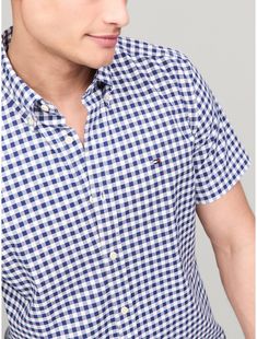 Tommy Hilfiger men's shirt. Embrace classic easy-going style with this Oxford shirt cut in a regular fit, and distinguished by an all-over gingham check and subtle Tommy Hilfiger branding.  Material: 98% Organic Cotton, 2% Elastane. Classic Gingham Top For Business, Business Gingham Cotton Top, Classic Gingham Tops, Classic Tommy Hilfiger Shirt For Summer, Tommy Hilfiger Classic Summer Shirt, Classic Tommy Hilfiger Summer Shirt, Gingham Shorts, Gingham Check, Easy Going