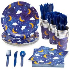 a set of blue and yellow dinnerware with stars and moon designs on it, including forks, knives, napkins, spoons and cups