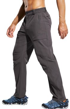 a man in grey pants and no shirt is standing with his hands on his hips