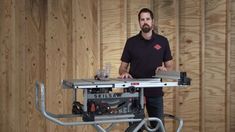 a man standing next to a table saw