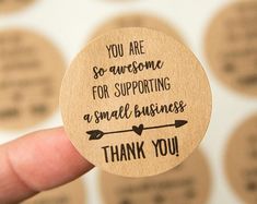 someone is holding up a wooden sticker that says, you are awesome for supporting a small business thank you