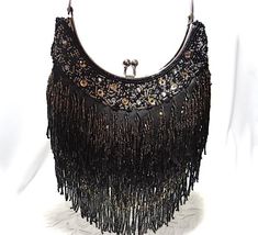 - Gorgeous black satin beaded fringe Deco style vintage evening bag...beautiful condition!- Beautiful gold and gunmetal bugle and seed bead long fringe design on both sides- Rhinestone and sequin border at top edge of silver framed pouch style bag- Twist top opening in  silver...frame scissors open- Handbag measures 6-1/2" wide X 6" center front length X 2"To see all of my Vintage Handbags click on this link....https://www.etsy.com/your/shops/TanglewoodTrims/tools/listings/section:21125977To see Rectangular Fringe Evening Bag For Party, Rectangular Evening Bag With Fringe, Elegant Evening Bags With Beaded Fringe, Glamorous Evening Bags With Fringe, Glamorous Evening Bags With Tassels, Evening Rectangular Bags With Beaded Fringe, Elegant Shoulder Bag With Beaded Fringe For Party, Elegant Evening Bag With Beaded Fringe, Rectangular Fringe Clutch For Evening