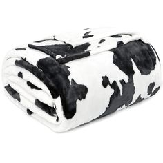 a black and white cow print blanket