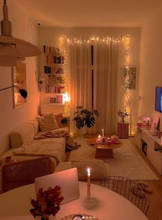 a living room filled with furniture and a flat screen tv on top of a wooden table