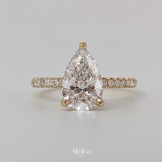 a pear shaped diamond engagement ring with side stones