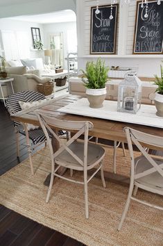 a dining room table with chairs and plants on it