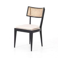 a black and white chair with a woven seat pad on it's backrest