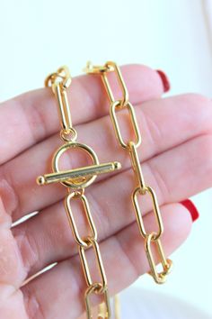 "This is a thick 14k gold-filled chain choker with toggle front. Links are 1.5mm thick, 16x7mm. Model is wearing a 15\" length, choose your length. Comes ina cute gift box." Gold Chain Bracelet With Toggle Clasp And Rectangular Links, Minimalist Chunky Chain Toggle Necklace Gift, Rectangular Links Toggle Necklace As Gift, Gift Toggle Necklace With Rectangular Chain Links, Metal Toggle Necklace With Oval Link Gold Chain, Oval Link Toggle Necklace With Gold Chain, Gold Link Choker For Gifts, Gift Toggle Necklace With Rectangular Links, Gold Chain Link Toggle Necklace