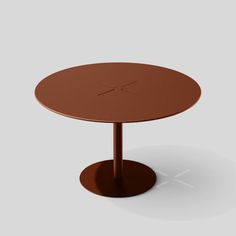 a round table with an x design on the top, and a small circular base