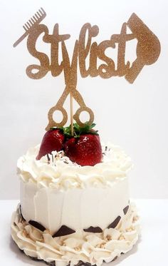 a white cake topped with strawberries and a pair of scissors on top of it