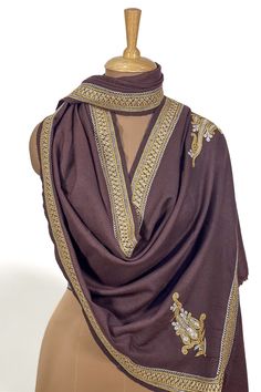 Wrap yourself in the timeless allure of Kashmiri Stoles. This Dove Grey Pure Pashmina Tilla Hand Embroidered Stole is a masterpiece, blending tradition and modernity flawlessly. It exudes regal elegance and embraces your beauty in every way possible. Product Details - Condition: Brand New - Style: Stole Wrap - Fabric: 100% Pure Pashmina - Wrap Feel: Soft - Weave: Tight Weave - Embroidery: Hand Tilla Work - Size: 28″ X 80″ (70 cm X 200 cm) approx. - Base Colour: Dove Grey - Embroidery Colour: Mul