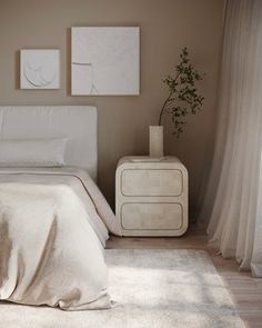 a white bed sitting in a bedroom next to a window with curtains on both sides