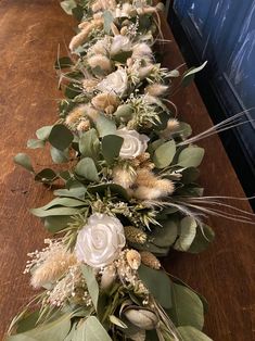 a long table with flowers and greenery on it