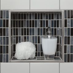 a soap dispenser sitting on top of a shelf next to a foamy ball