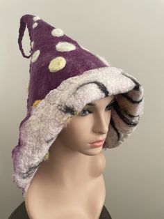 Beautiful felted toadstool hat. Made by myself with very soft Australian Merino wool. Purple with white and yellow dots. Striped inside. Can be folded over to reveal striped side. Unique Winter Brimmed Hat, Unique Brimmed Winter Hat, Handmade Wide Brim Winter Costume Hats, Handmade Winter Felt Hat, One Size, Whimsical Winter Hat With Short Brim, Handmade Winter Felt Hat With Curved Brim, Handmade Winter Felt Hat, Handmade Winter Felt Hat In One Size, White Wool Cap