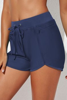 Bottom type: ShortsPattern type: SolidStyle: BeachFeatures: Drawstring, PocketedMaterial composition: 82% nylon, 18% spandexStretch: Highly stretchyCare instructions: Machine wash cold. Tumble dry low.ImportedProduct measurements:S: hip 37.8 in, front rise 11.4 in, inseam 2.7 in, waist 25.7 inM: hip 39.4 in, front rise 11.6 in, inseam 2.7 in, waist 27.3 inL: hip 41.7 in, front rise 12.2 in, inseam 2.7 in, waist 29.6 inXL: hip 44.1 in, front rise 12.8 in, inseam 2.9 in, waist 32 in2XL: hip 45.6 i Beach Bottoms With Tie-side And Functional Drawstring, Casual Swim Skirt With Drawstring For Vacation, Casual Vacation Swim Skirt With Drawstring, Athleisure Stretch Swimwear With Drawstring, Stretch Swimwear With Pockets For Beach, Sporty Stretch Bottoms For Vacation, Sports Bottoms With Built-in Shorts And Tie-sides, Vacation Bottoms With Moisture-wicking Stretch Fabric, Stretchable Beachwear Swimwear With Pockets