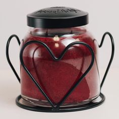 a red candle with a black heart on it