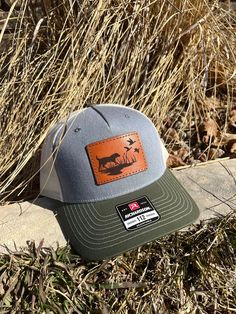 These leather patch Richardson 112FP hats are a great way to flaunt your style and look sleek at the same time. Patches made from 100% leather and engraved with a crisp design and hand stitched on our most popular style of hat. Your friends are going to be jealous! To submit custom logo- Please email brent@lumberjackdesignco.com with the Vector logo, it will be labeled .eps, .ai, .pdf (Please do not submit a jpg in this format as this will need redrawn and art charges will apply for hourly rates!) Multiple hat colors available, Bulk pricing available (see below) custom shape patches available upon request. SIZE OF PATCH HEIGHT WILL VARY DEPENDING ON CUSTOMER LOGO If a hat color is not listed please message us and we can order in a custom color if needed. Outdoor Short Brim Hats With Logo Patch, Western Trucker Hat With Leather Patch For Outdoor, Brown Hunting Hat With Leather Patch, Brown Leather Patch Hunting Hat, Outdoor Trucker Hat With Leather Patch And Short Brim, Western Hats With Leather Patch For Outdoor, Western Style Outdoor Snapback Hat With Short Brim, Western Outdoor Hat With Leather Patch, Western Style Snapback Hat With Short Brim For Outdoor