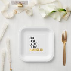 a white plate with the words joy, love, lake, peace and hanukkah on it