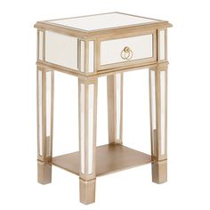 a white and gold side table with drawers