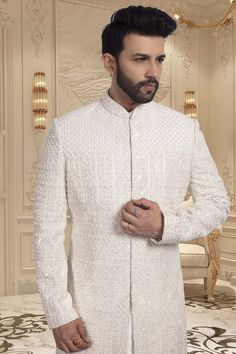 Introducing the ultimate luxury for grooms - our Mens Sherwani R14-S059. Featuring intricate cutdana and stone embroidery, this sherwani exudes elegance and sophistication. Make a statement on your special day with this stunning and exclusive piece. Wedding Suits With Dabka And Traditional Drape, Traditional Drape Wedding Suits With Dabka, Dabka Embellished Wedding Suits With Traditional Drape, Elegant Sherwani With Chikankari Embroidery For Festivals, Elegant Sherwani With Intricate Embroidery For Diwali, Traditional Nehru Jacket With Naqshi For Wedding, Luxury Formal Kurta With Intricate Embroidery, Elegant Sherwani With Dabka Work And Traditional Drape, Elegant Sherwani For Reception With Traditional Drape