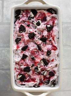 an ice cream dish with cookies and cherries in it