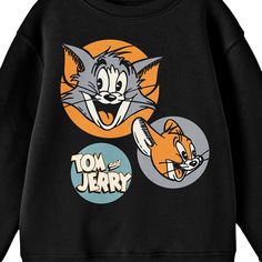 Celebrate your favorite cartoons in comfort with this Tom & Jerry sweatshirt. The sweatshirt features illustrations of Tom and Jerry in orange and in orange and gray circles while the series logo appears in a blue circle next to the characters. The sweatshirt comes in a black long sleeve crew neck. Tom & Jerry fans will love this comfy and cozy sweatshirt. Tom And Jerry Sweatshirt, Cartoon Style Cotton Top With Letter Print, Cotton Cartoon Style Tops With Letter Print, Cotton Cartoon Print Tops, Cotton Cartoon Character Print Tops, Cotton Cartoon Tops With Character Print, Cotton Tops With Cartoon Character Print, Retro Long Sleeve Sweatshirt With Cartoon Print, Retro Cartoon Print Sweatshirt For Winter